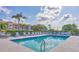 Well-maintained community pool with clear water, lounge chairs, and a building in the background at 9630 Club South Cir # 6303, Sarasota, FL 34238