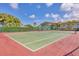 Well-maintained tennis court surrounded by lush greenery and blue skies at 9630 Club South Cir # 6303, Sarasota, FL 34238