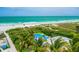 Breathtaking aerial view showcases a waterfront property with a pool and lush tropical surroundings at 102 77Th St, Holmes Beach, FL 34217