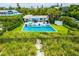 Charming home with a private pool and patio area, surrounded by well-manicured landscaping and a path to the beach at 102 77Th St, Holmes Beach, FL 34217