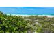 Direct beach access through natural dunes with lush greenery, perfect for nature lovers at 102 77Th St, Holmes Beach, FL 34217