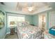 Bright bedroom with a queen bed with windows and a ceiling fan at 102 77Th St, Holmes Beach, FL 34217