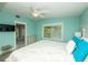 Bedroom with light blue walls, window, and view into bathroom at 102 77Th St, Holmes Beach, FL 34217