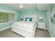 Bedroom with light blue walls, a white bed frame, and matching bedside tables at 102 77Th St, Holmes Beach, FL 34217
