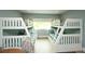 Bedroom featuring two sets of bunk beds with coastal-themed bedding and decor at 102 77Th St, Holmes Beach, FL 34217