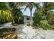 Charming single-story home with a well-maintained, xeriscaped front yard featuring lush landscaping at 102 77Th St, Holmes Beach, FL 34217