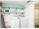 Laundry room featuring a washer, dryer, and shelving at 102 77Th St, Holmes Beach, FL 34217