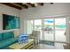 Bright living room view from inside through sliding glass doors to an outdoor patio at 102 77Th St, Holmes Beach, FL 34217