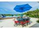 Inviting outdoor dining area with a view of the pool and beach, perfect for entertaining guests at 102 77Th St, Holmes Beach, FL 34217