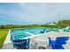 Beautiful backyard pool and spa with lounge chairs on a wooden deck and picturesque ocean view at 102 77Th St, Holmes Beach, FL 34217