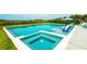 Sparkling pool with integrated spa and lounge area, ideal for relaxing and entertaining at 102 77Th St, Holmes Beach, FL 34217
