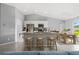 Open kitchen featuring a center island with bar seating, stainless appliances, and modern finishes at 10547 Kidron Ave, Englewood, FL 34224