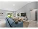 Inviting living room with large windows, comfortable seating, and a vaulted ceiling for a spacious feel at 10547 Kidron Ave, Englewood, FL 34224