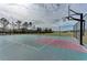 Fenced outdoor community basketball court with a green and red playing surface at 11254 82Nd St E, Parrish, FL 34219