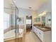 Bathroom with a tub, glass shower, and double sink vanity, and bedroom access at 11254 82Nd St E, Parrish, FL 34219