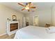 Spacious bedroom featuring wood floors, a ceiling fan, and an ornate fireplace at 11254 82Nd St E, Parrish, FL 34219