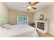 Bedroom view showcases a window overlooking the pool, and a decorative fireplace at 11254 82Nd St E, Parrish, FL 34219