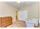 Bedroom showcasing wood-style flooring, a closet, dresser, chair, and neutral-colored walls and trim at 11254 82Nd St E, Parrish, FL 34219
