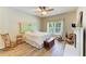 Comfortable bedroom featuring wood floors, a ceiling fan, and a decorative fireplace at 11254 82Nd St E, Parrish, FL 34219