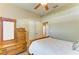 Bedroom with light-colored walls, ceiling fan, a dresser and mirror combo, and a double door closet at 11254 82Nd St E, Parrish, FL 34219