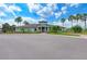 Community clubhouse surrounded by landscaping, including palm trees and shrubs at 11254 82Nd St E, Parrish, FL 34219