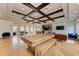 Community clubhouse featuring coffered ceilings, a large table, seating, and recreational game area at 11254 82Nd St E, Parrish, FL 34219
