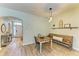 Cozy dining area adjacent to the front door features wood floors and seating for four at 11254 82Nd St E, Parrish, FL 34219