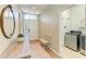 Front entrance foyer with decor leading to a laundry room with modern washer and dryer appliances at 11254 82Nd St E, Parrish, FL 34219