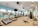 Community gym featuring treadmills, elliptical machines, weightlifting equipment, and multiple ceiling fans at 11254 82Nd St E, Parrish, FL 34219