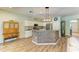 Charming kitchen featuring white cabinets, stainless steel appliances, and stylish wood-clad island at 11254 82Nd St E, Parrish, FL 34219