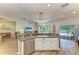Kitchen island with bar seating offering an open layout to the living room and patio at 11254 82Nd St E, Parrish, FL 34219
