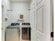Laundry room with a stainless steel washer and dryer and storage space for household chores at 11254 82Nd St E, Parrish, FL 34219