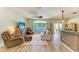 Inviting living room featuring a ceiling fan and a large window overlooking the pool at 11254 82Nd St E, Parrish, FL 34219