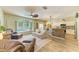 Open-concept living area connecting to the kitchen with bar seating and a pool view at 11254 82Nd St E, Parrish, FL 34219
