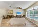 Bright living space offering a view of the pool, an open layout, and wood floors at 11254 82Nd St E, Parrish, FL 34219