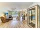 Open living area with wood-style floors, comfy seating, and a decorative display cabinet at 11254 82Nd St E, Parrish, FL 34219