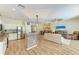 Open living area with a kitchen, stainless steel appliances, and wood flooring at 11254 82Nd St E, Parrish, FL 34219