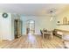 Open-concept living space seamlessly integrates the dining area and entryway, featuring stylish wood flooring at 11254 82Nd St E, Parrish, FL 34219