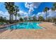 Community pool with clear blue water, plenty of lounge chairs, and a brick pool deck on a sunny day at 11254 82Nd St E, Parrish, FL 34219