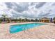 Community pool with clear blue water, plenty of lounge chairs, and a brick pool deck on a sunny day at 11254 82Nd St E, Parrish, FL 34219