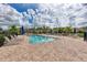 Community pool with clear blue water, plenty of lounge chairs, and a brick pool deck on a sunny day at 11254 82Nd St E, Parrish, FL 34219