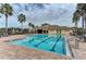 Community pool with clear blue water, plenty of lounge chairs, and a brick pool deck on a sunny day at 11254 82Nd St E, Parrish, FL 34219