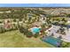 Community pool with a playground and sports court with views of the lake and surrounding neighborhood at 11254 82Nd St E, Parrish, FL 34219