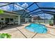 Beautiful kidney-shaped pool enclosed in a screened lanai with brick pavers at 11254 82Nd St E, Parrish, FL 34219