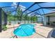 Relax in this kidney-shaped pool inside a screened lanai with brick paver deck at 11254 82Nd St E, Parrish, FL 34219