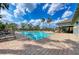 Community pool with clear blue water, plenty of lounge chairs, and a brick pool deck on a sunny day at 11254 82Nd St E, Parrish, FL 34219