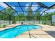Sparkling kidney-shaped pool surrounded by a screened lanai and a well-maintained brick paver deck at 11254 82Nd St E, Parrish, FL 34219