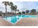 Community pool with clear blue water, plenty of lounge chairs, and a brick pool deck on a sunny day at 11254 82Nd St E, Parrish, FL 34219