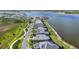 Aerial showcasing the long view of waterfront homes with community walking trail and lakefront setting at 1182 Blue Shell Loop, Sarasota, FL 34240