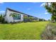 Well-manicured backyard with palms and lush greenery and water view at 1182 Blue Shell Loop, Sarasota, FL 34240